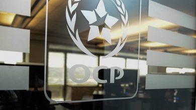 A glass wall with the OCP group's logo
