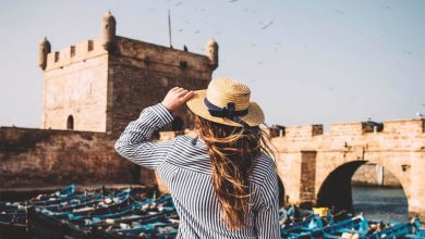 A picture of the back of a girl wearing a lined shirt and a hat in Essaouira, Morocco.