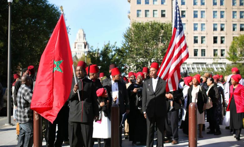 Most African-Americans are actually Moroccans Moors Moorish : Black man holding Moroccan US flag